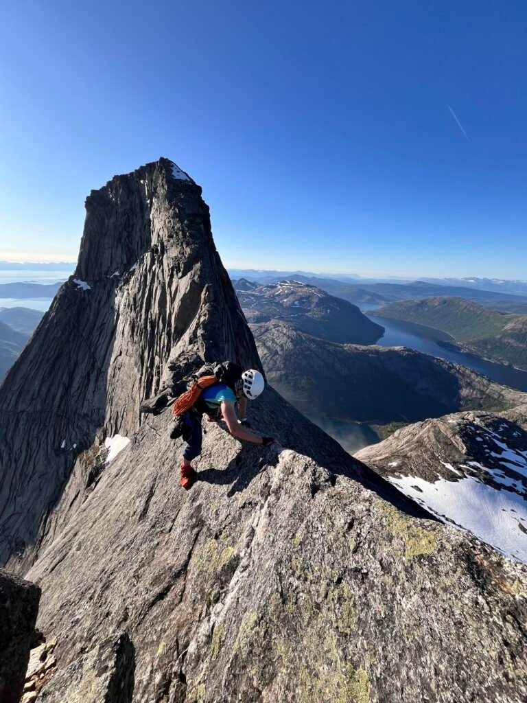 Woman traversing along a mountain ridge